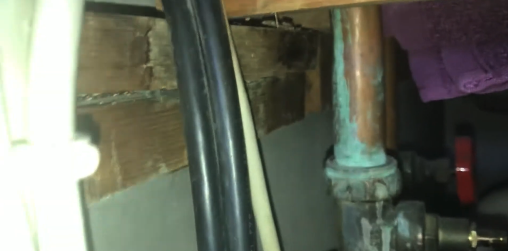 corroded pipes under the kitchen sink