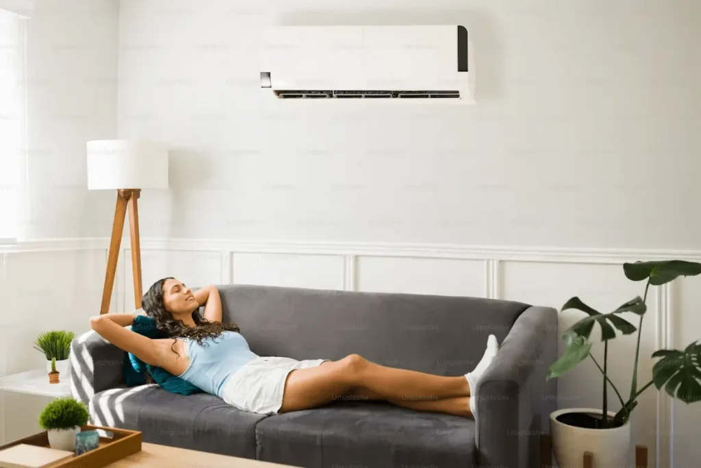 image of a woman enjoying a split system air conditioner