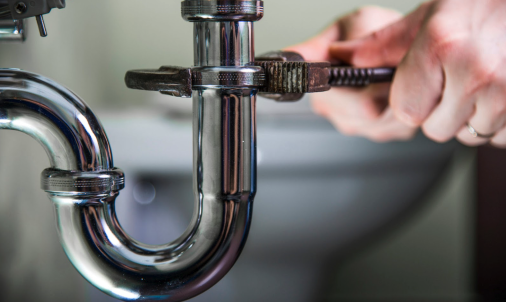 tightening the pipe under the kitchen sink