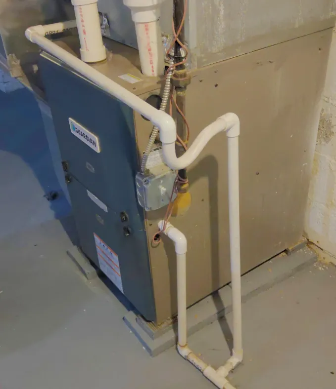 Air handler unit with PVC drain line for removing condensation from the system