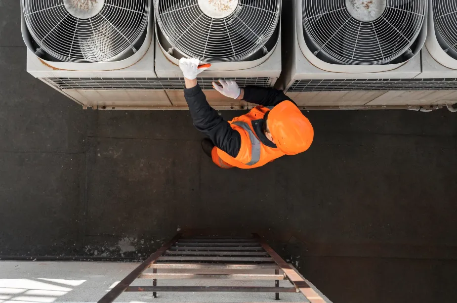 Technician performing routine maintenance on a 2,5 ton AC unit to ensure long-term performance.