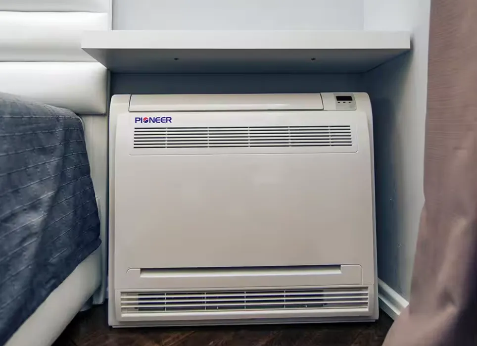 A floor console AC unit installed under a shelf