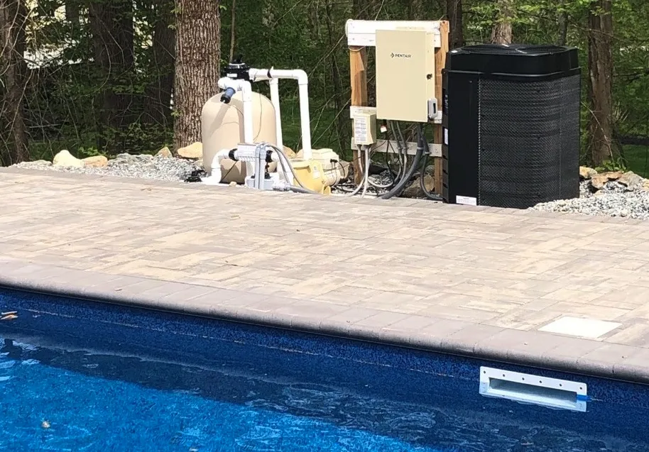Close-up of an electric resistance pool heater unit, a common choice for those learning how to heat a pool on a budget