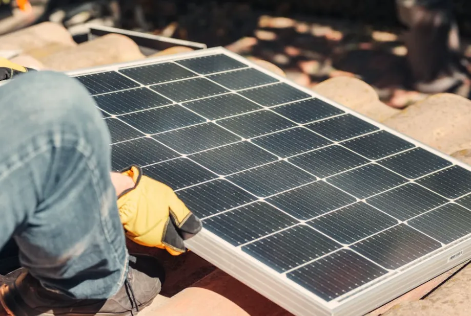 High-efficiency solar panel being mounted to a roof to provide eco-friendly heat