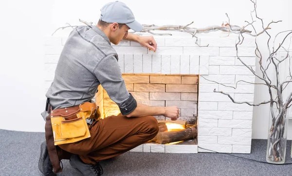 Fireplace installation in white brick wall