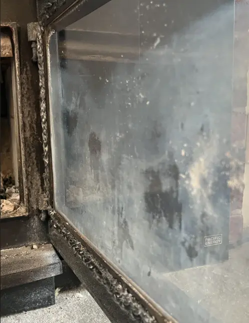 You can safely clean the glass panel yourself but leave burner ports to the technician